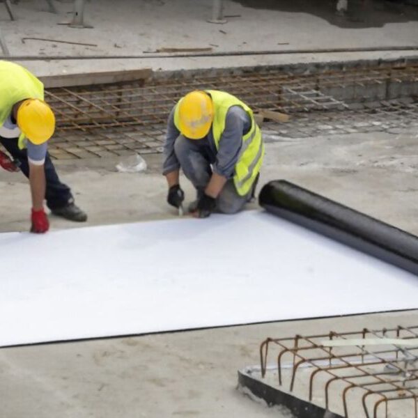 two workers cutting the carpet