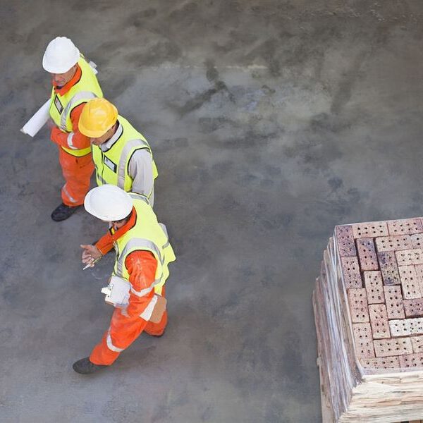 three workers talking to each other